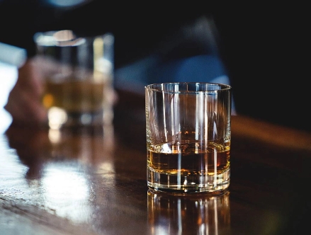 A glass of whiskey on bar table